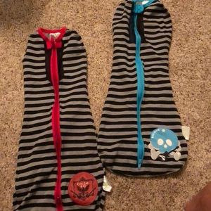 Two woombie baby zip up swaddles